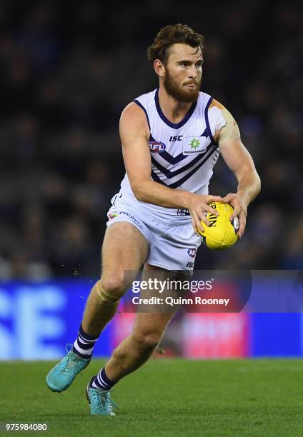 Connor Blakely of the Dockers kicks during the round 13 AFL match between the Carlton Blues and the Fremantle Dockers at Etihad Stadium on June 16,...