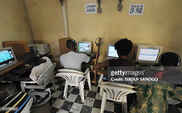 Young people browsing the Internet in a cybercafe in Abidjan on August 11, 2009. The Ivory Coast, the economic powerhouse of west Africa, has also...