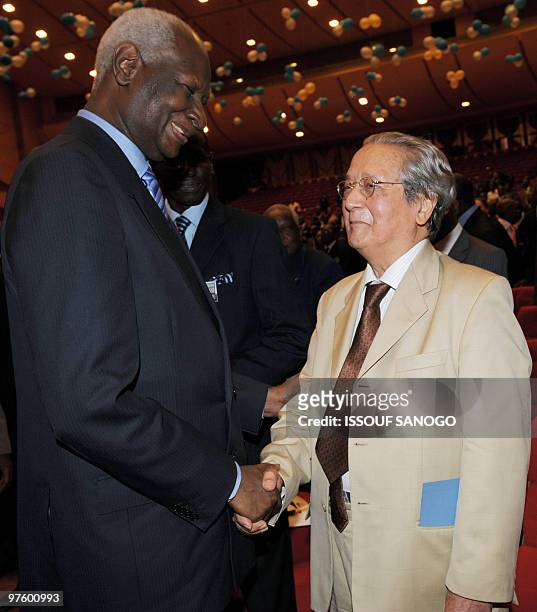 Ex-president of Senegal Abdou Diouf shakes hands with French advocate Jacques Verges during the 50th anniversary celebration ceremony of the Bar in...
