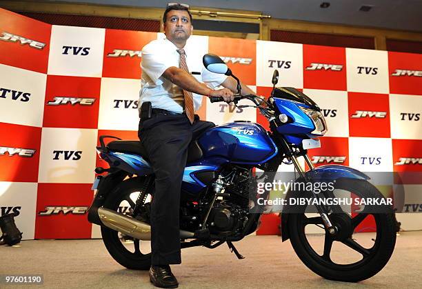 Vice-President-Sales of India's TVS Motor Company R. Dilip poses on a newly launched TVS Jive motorcycle during a press conference in Bangalore on...