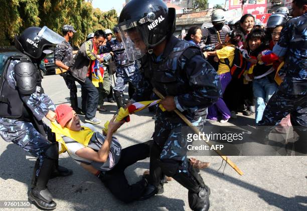 Nepalese riot police arrest Tibetan protesters in front of the consular section of the Chinese Embassy in Kathmandu on March 10 as they stage a...