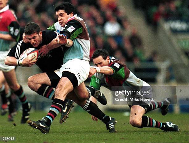 Tom May of Newcastle is stopped by Nick Greenstock and Ryan O''Neill of Quins during the match between NEC Harlequins and Newcastle Falcons in the...