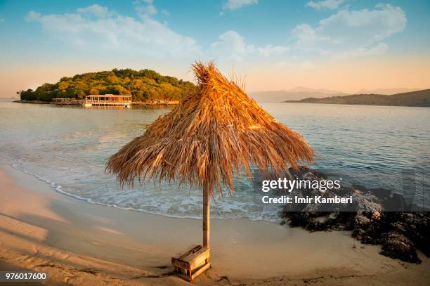 landscape of sandy beach with umbrella, ksamil, albania - kambiri stock pictures, royalty-free photos & images