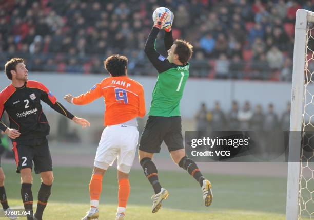 Eugen Galekovic of Adelaide United competes for an aerial ball during the AFC Champions League Group H match between Shandong Luneng and Adelaide...