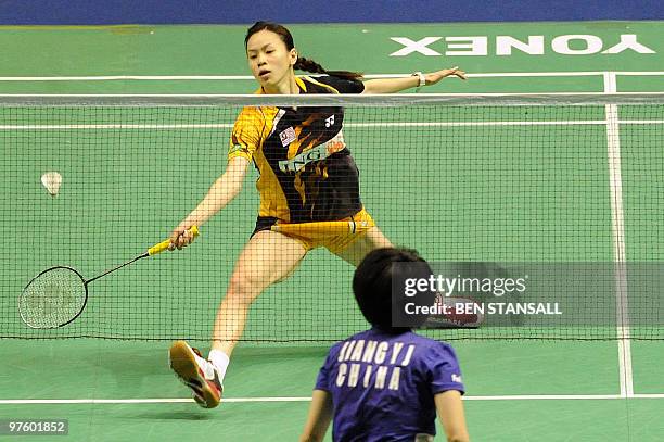 Malaysia's Mew Choo Wong returns a shot to China's Yanjiao Jiang during their woman's singles first round match at the Badminton All England Open...