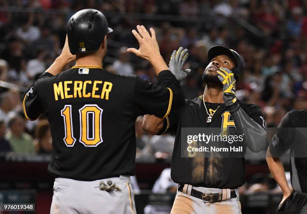 Starling Marte of the Pittsburgh Pirates celebrates with teammate Jordy Mercer after hitting a three run home run off of Clay Buchholz of the Arizona...