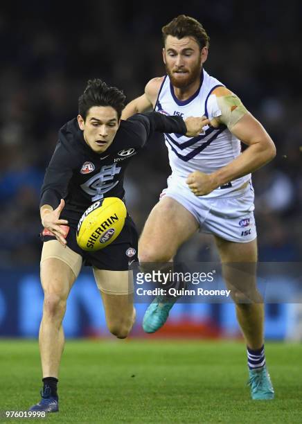 Zac Fisher of the Blues and Connor Blakely of the Dockers compete for the ball during the round 13 AFL match between the Carlton Blues and the...