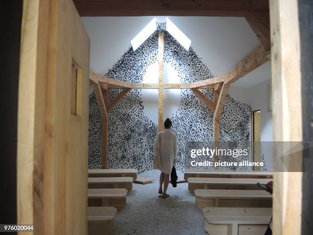 May 2018, Italy, Venice: A visitor walks through one of ten chapels on the island of San Giorgio Maggiore, designed by ten architects from around the...