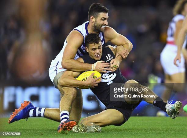 Ed Curnow of the Blues is tackled by Shane Kersten of the Dockers during the round 13 AFL match between the Carlton Blues and the Fremantle Dockers...