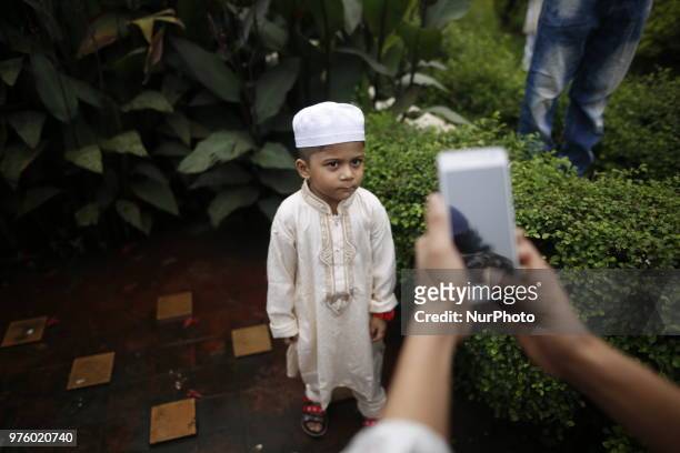 Dhaka, Bangladesh. A Bangladeshi child is taken by a photograph as the Muslims celebrate Eid-ul-Fitr festival in Dhaka, Bangladesh on June 16, 2018....