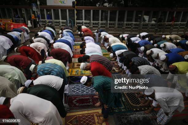 Dhaka, Bangladesh. Bangladeshi Muslim devotees take part in Eid-ul-Fitr prayer on a road near National Eidgah premises in Dhaka, Bangladesh on June...