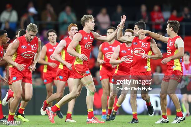 Tom Lynch of the Suns celebrates a goal during the round 13 AFL match between the Gold Coast Suns and the St Kilda Saints at Metricon Stadium on June...