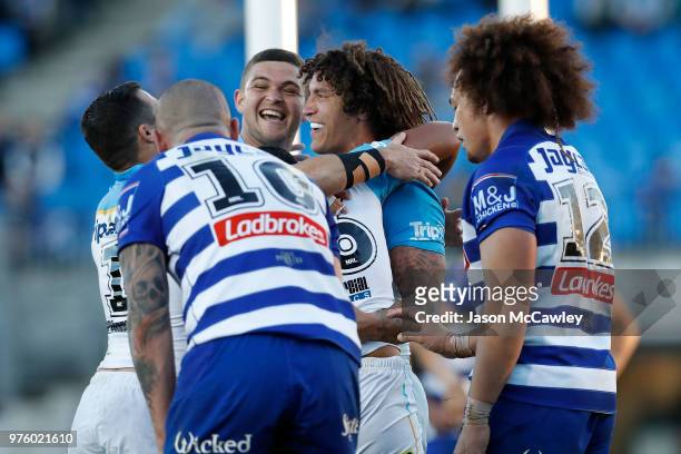 Kevin Proctor of the Titans celebrates with team mates after scoring a try during the round 15 NRL match between the Canterbury Bulldogs and the Gold...