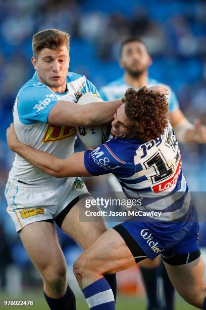 Jai Arrow of the Titans is tackled Adam Elliott of the Bulldogs during the round 15 NRL match between the Canterbury Bulldogs and the Gold Coast...