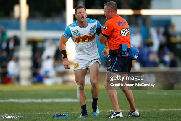 Michael Gordon of the Titans receives attention for an injury during the round 15 NRL match between the Canterbury Bulldogs and the Gold Coast Titans...