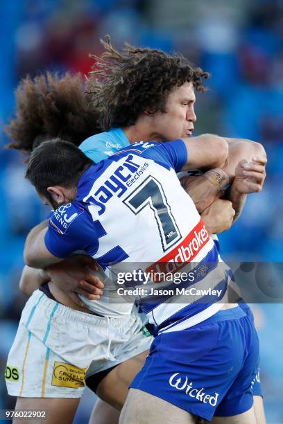 Kevin Proctor of the Titans is tackled by Matt Frawley of the Bulldogs during the round 15 NRL match between the Canterbury Bulldogs and the Gold...