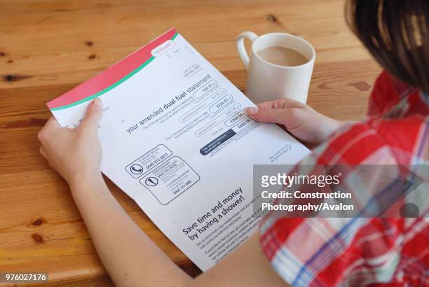 Young person looking at utility bill.