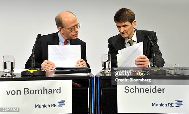 Nikolaus von Bomhard, chief executive officer of Munich Re, left, and Joerg Schneider, chief financial officer of Munich Re, attend a press...