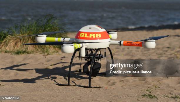 May 2018, Germany, Jork: A drone of the Deutsche Lebens-Rettungs-Gesellschaft relief organization fitted with a thermal imaging camera at a beach by...