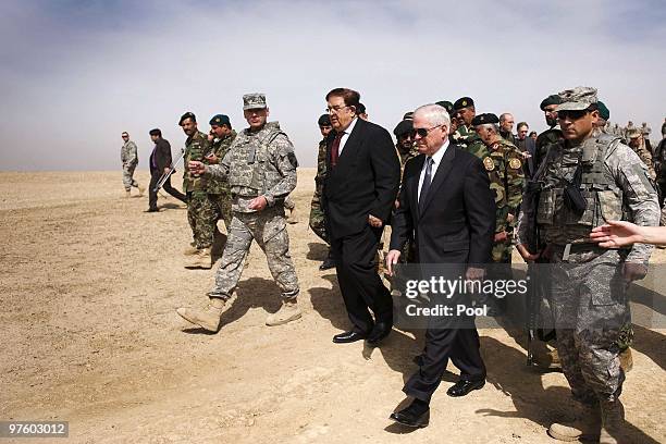 Secretary of Defense Robert Gates walks with Afghan Defense Minister Abdul Rahim Wardak as they tour Camp Blackhorse training grounds on March 10,...