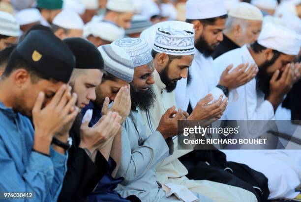 Muslims take part in prayers held to mark the end of Ramadan and the start of Eid al-Fitr at Saint Denis on Reunion early June 16, 2018.