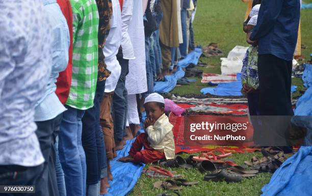 Muslim kid looks on as elders offer prayer during Eid-al-Fitr in Dimapur, India north eastern state of Nagaland on Saturday, June 16, 2018.Muslims...