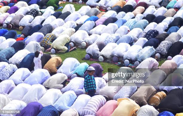 Muslim kid looks on as elders offer prayer during Eid-al-Fitr in Dimapur, India north eastern state of Nagaland on Saturday, June 16, 2018.Muslims...