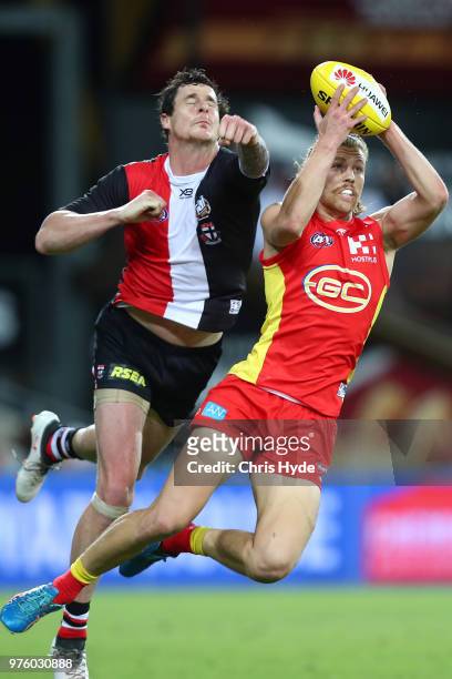 Aaron Young of the Suns takes a mark during the round 13 AFL match between the Gold Coast Suns and the St Kilda Saints at Metricon Stadium on June...