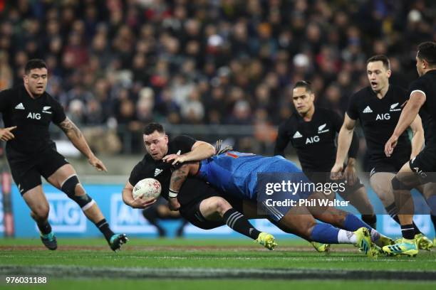 Ryan Crotty of the New Zealand All Blacks is tackled during the International Test match between the New Zealand All Blacks and France at Westpac...