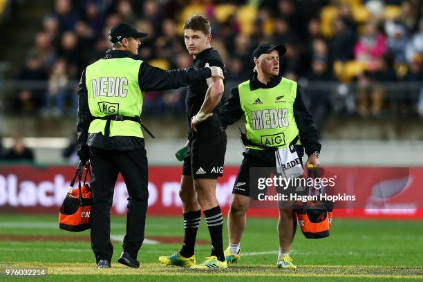 Beauden Barrett of New Zealand receives medical attention after attempting to take a high ball during the International Test match between the New...