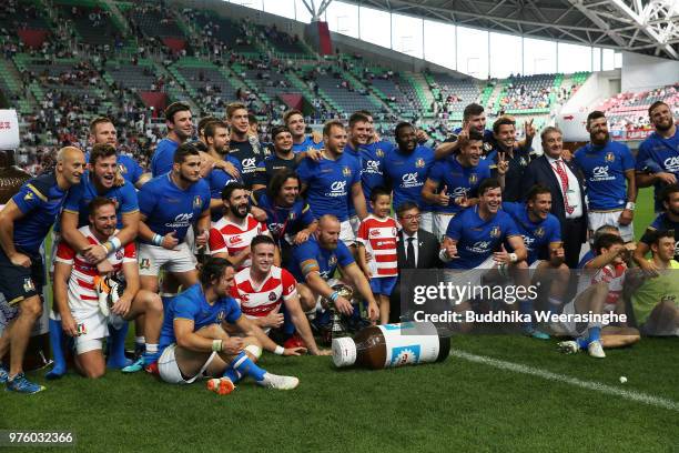 Players pose for photographs after the rugby international match between Japan and Italy at Noevir Stadium Kobe on June 16, 2018 in Kobe, Hyogo,...