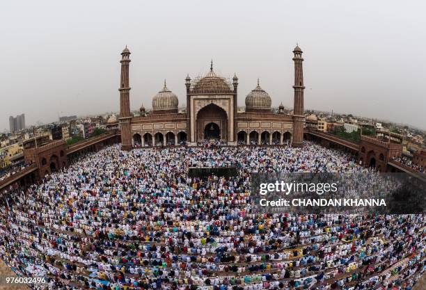 Indian Muslims offer Eid al-Fitr prayers at the Jama Masjid mosque in New Delhi on June 16, 2018. - Muslims around the world celebrated Eid al Fitr...