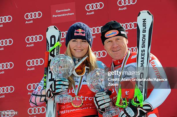 Overall season winners Lindsey Vonn of the USA and Didier Cuche of Switzerland pose with the globe for the World Cup Downhill during the Audi FIS...