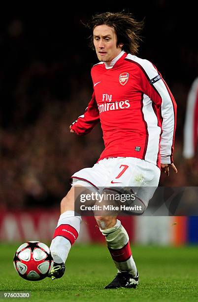 Tomas Rosicky of Arsenal passes the ball during the UEFA Champions League round of 16 match between Arsenal and FC Porto at the Emirates Stadium on...