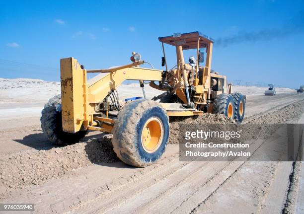 Grader levels the desert ground for road base and later asphalting Dubai, UAE.