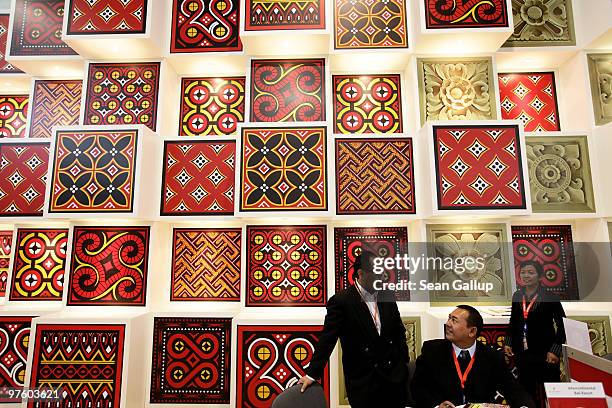 Trade fair visitors talk under ornate patterns at the Indonesia stand at the ITB Berlin travel trade show on March 10, 2010 in Berlin, Germany. The...