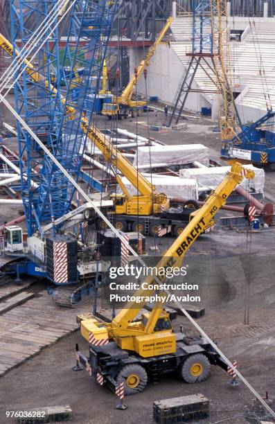 Wheeled mini crane and tracked heavy duty crane Gelsenkirchen Stadium Germany .