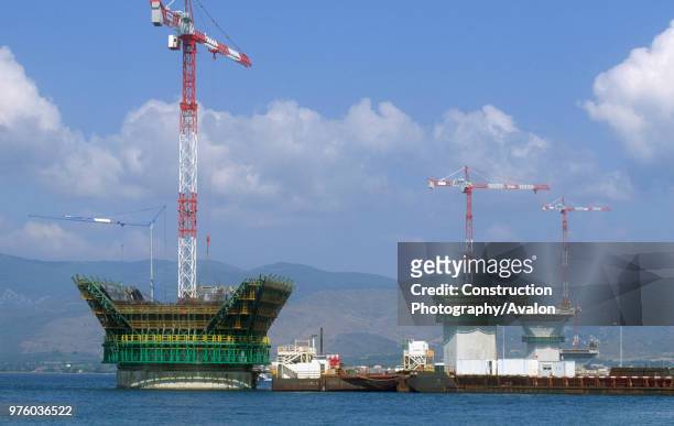 Widening the tops of recently floated in caissons forming the piers for the Rion-Antirion road bridge across the Gulf of Corinth in Greece: Potain...