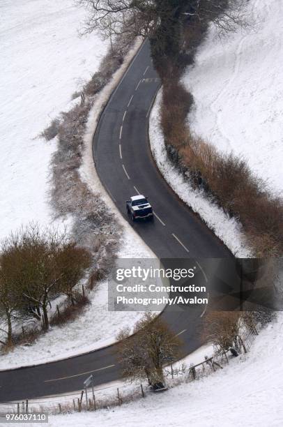 Road treated with salt during snowy conditions near Frocester, Gloucestershire, UK.