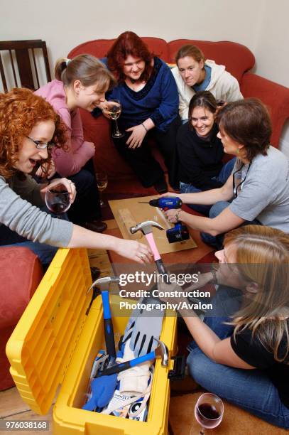 Female DIY enthusiasts at a power tools party UK.