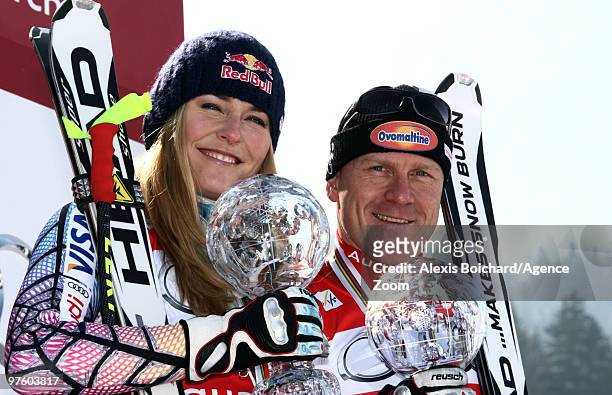 Lindsey Vonn of the USA and Didier Cuche of Switzerland take the globe for the overall World Cup Downhill during the Audi FIS Alpine Ski World Cup...