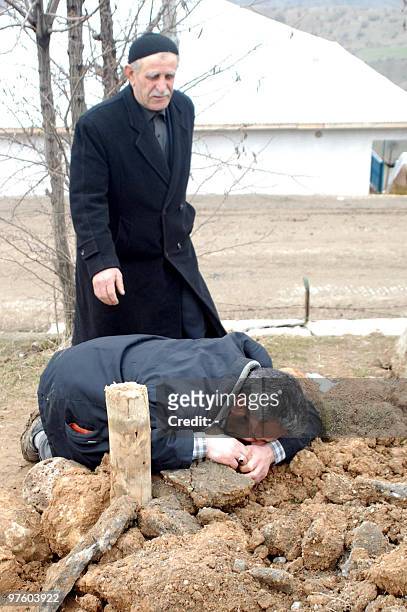 The relative of earthquake victims mourns at the cemetery of the village of Okcular in the eastern Turkish province of Elazig on March 9 a day after...
