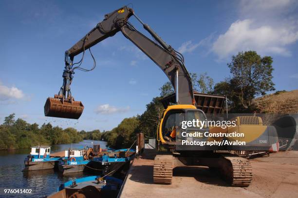 Unloading aggregates from a barge on The River Severn at Ryall Dock Worcestershire UK.