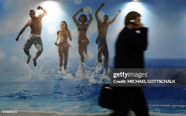 Trade fair visitor walks past the stand of Greece at the ITB travel trade fair at the fair grounds in Berlin, on March 10, 2010. The exhibition takes...