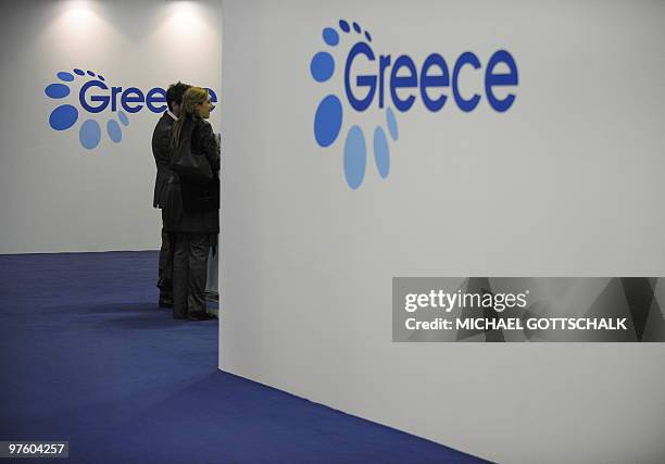 Trade fair visitor walks past the stand of Greece at the ITB travel trade fair at the fair grounds in Berlin, on March 10, 2010. The exhibition takes...