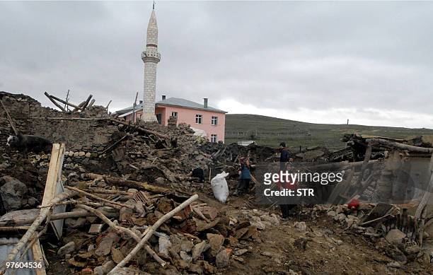 Villagers search among the ruins in Okcular village in the eastern province of Elazig, on March 9 a day after a strong earthquake, with a preliminary...