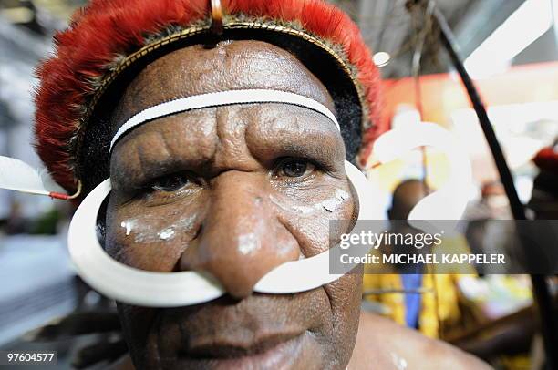 Man from the Indonesian Island Papua poses for a photo at the ITB travel trade fair at the fair grounds in Berlin, on March 10, 2010. The exhibition...
