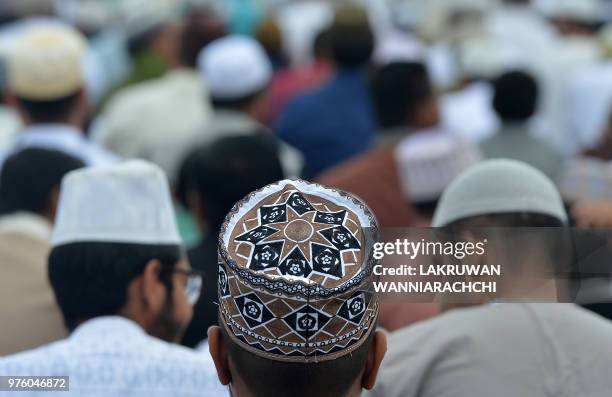 Sri Lankan Muslim men pray during Eid Al-Adha celebrations at the Galle Face esplanade in Colombo on June 16, 2018. - Muslims around the world...