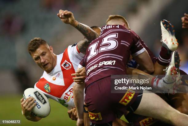 Tariq Sims of the Dragons is tackled during the round 15 NRL match between the St George Illawarra Dragons and the Manly Sea Eagles at WIN Stadium on...