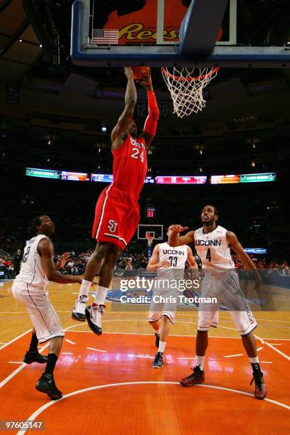 Justin Burrell of the St. John's Red Storm dunks the ball over the Connecticut Huskies at Madison Square Garden on March 9, 2010 in New York, New...